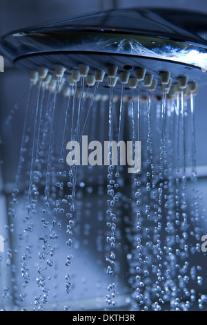 fließendes Wasser aus einem Duschkopf mit Wasser Tropfen Stockfoto