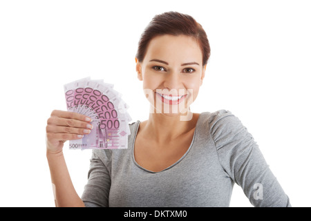 Schöne lockere Frau halten Geld. Isoliert auf weiss. Stockfoto