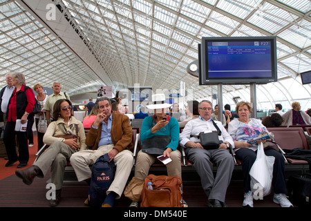 Reisende in einem Wartezimmer bei Charles de Gaulle Airport, Paris, Frankreich. Stockfoto