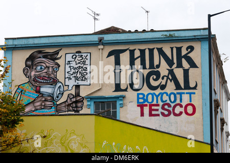 Denken Sie, dass lokale boykottieren Tesco Slogan auf Wand in Stokes Croft Bereich von Bristol. Stockfoto