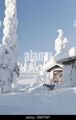 Verschneite Holz gemacht Hütten oder Blockhütten im verschneiten Wald in Riisitunturi, Finnland Stockfoto