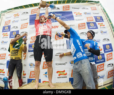 8. November 2005; Florianopolis, Santa Catarina, Brasilien; DAMIEN HOBGOOD (Satellite Beach, Fl, USA) (C) feiert seinen Sieg in einem Regen von Fosters Bier, nachdem er die Nova Schin Festival präsentiert von Billabong Titel bei Imbituba, Brasilien heute holte. Hobgood besiegte eng Publikumsliebling VICTOR RIBAS (Bra) (L), um seinen ersten Sieg der Saison 2005 ASP WCT behaupten und US$ 30 000 in p Stockfoto