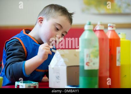 Dresden, Deutschland. 5. Dezember 2013. Fünf-jährige Valentino mit Down Syndrom sitzt während der Ergotherapie in einem Therapieraum im Sociopediatric-Zentrum (SPZ) am Klinikum Dresden-Neustadt in Dresden, Deutschland, 5. Dezember 2013. (Model-Release verfügbar) Foto: Sebastian Kahnert/Dpa/Alamy Live News Stockfoto