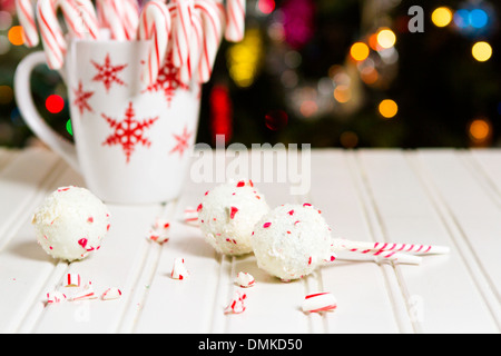 Pfefferminze, die Schoko-Cake pops in weißer Schokolade und Süßigkeiten Zuckerrohr Bits getaucht. Stockfoto