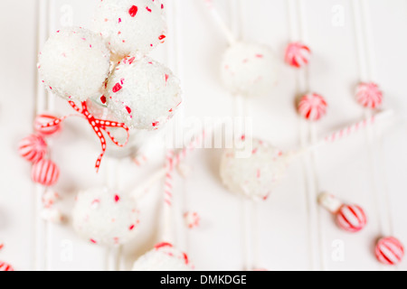 Pfefferminze, die Schoko-Cake pops in weißer Schokolade und Süßigkeiten Zuckerrohr Bits getaucht. Stockfoto