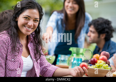 Eine Sommer-Party im Freien. Vier Freunde an einem Tisch. Stockfoto