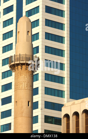 Minarett der Beit al-Quran gesehen gegen die Fassade eines modernen Bürogebäudes, Manama, Königreich von Bahrain Stockfoto
