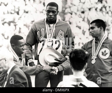 16. Oktober 1964 - Tokio, Japan - amerikanischen Läufer BOB HAYES, geboren Robert Lee Hayes, auf dem Podium seine Goldmedaille tragen, wie er die kubanische ENRIQUE FIGUEROLA (L), die den zweiten gratulieren der kanadischen HARRY JEROME Uhren Platz, nachdem die Männer 100 m-Finale in Tokio 1964 dritte war.  (Kredit-Bild: © KEYSTONE Pictures/ZUMAPRESS.com) Stockfoto