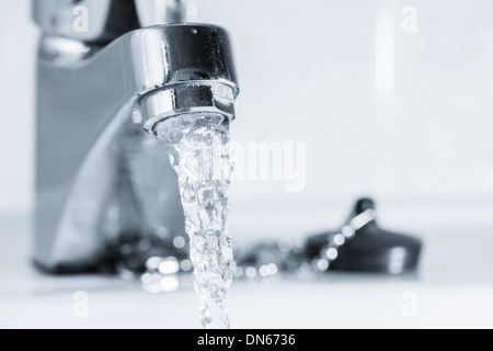 Offenen Wasserhahn im Bad, Wasser läuft, getöntem schwarz / weiß Bild Horizont format Stockfoto