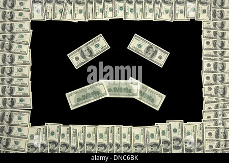 Trauriges Gesicht in Dollar Bill frame Stockfoto