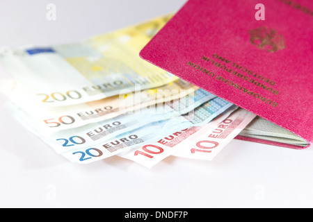 Mehrere Euro-Noten liegen in einem deutschen Reisepass für Reisen Stockfoto