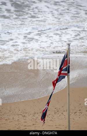 zerrissene Union Jack-Flagge in Bournemouth Beach im Dezember Stockfoto