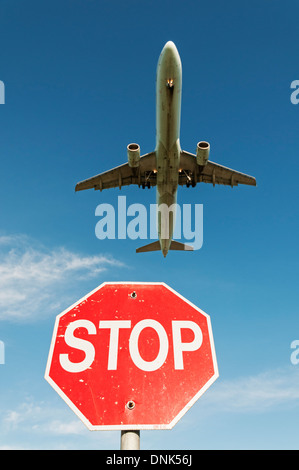 Verkehrsflugzeug im Endanflug zur Landung steigt über Stop-Schild kurz vor Ende der Landebahn des Flughafens Stockfoto