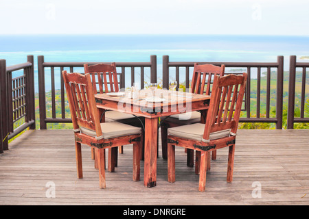 Außerhalb Esstisch und Stühle auf einem hölzernen Balkon Stockfoto