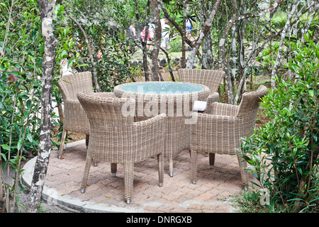 Rattan-Tisch und Stühlen in einem öffentlichen Garten Stockfoto