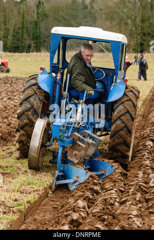 Bauer, der pflügt ein Feld in einem Traktor Stockfoto