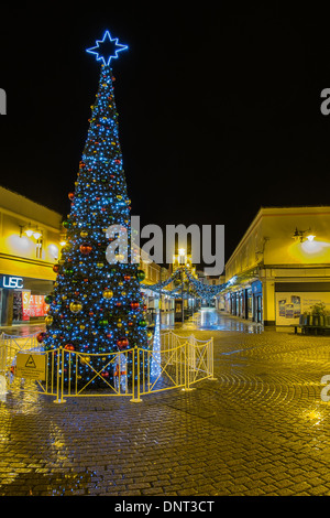 Weihnachtsbeleuchtung in Salisbury. Auf einem nassen kalten Abend mit bunten Reflexionen auf dem Bürgersteig. Stockfoto