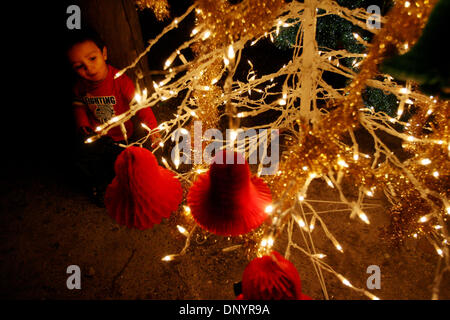 7. Februar 2006; Pahokee, FL, USA; Juanluis Paniagua, zwei, bewundert den Weihnachtsbaum auf einer Party von Larry Wright, der Pahokee, für die Bewohner von Ushers Trailer Park in Pahokee Dienstag organisiert. Bewohner des Parks waren ohne Strom für 101 Tage nachdem Hurrikan Wilma Bereich getroffen. Drei Kirchen aus dem Bereich brachte Geschenke, Nahrung und Kleidung für die Familien. Obligatorische Cred Stockfoto