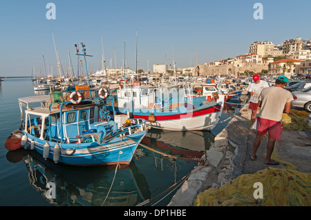 Zwei Fischer und Fischerboote im alten Hafen von Heraklion (Iraklion), Kreta, Griechenland Stockfoto