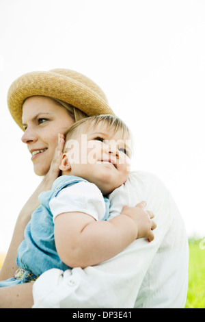 Mutter umarmt Baby Tochter im Freien, Mannheim, Baden-Württemberg, Deutschland Stockfoto