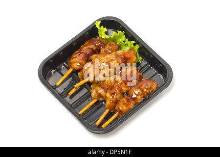 Chicken Teriyaki mit Spießen in schwarzer Schale isoliert auf weiss. Stockfoto