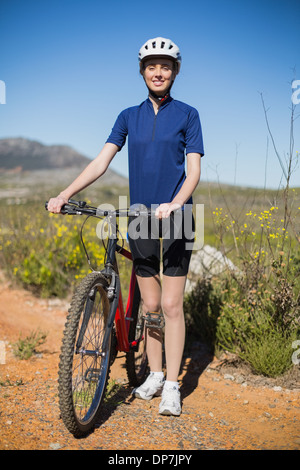 Frau stehend und halten Fahrrad Stockfoto