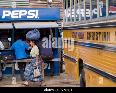 24. März 2006 - Antigua, Guatemala - Menschen in der Busbahnhof, wo ehemalige amerikanische Schulbusse jetzt als Guatemalas nah- und Fernverkehr Busse, teilweise mit alten Markierungen aus ihrem früheren Leben in Amerika, noch intakt ist dienen, kontrastieren mit der lokalen Kultur am Busbahnhof in der Stadt Antigua Guatemala (Credit-Bild: © David H. Wells/ZUMAPRESS.com) Stockfoto