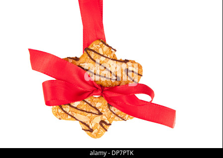 Sterne geformte Cookie Aufhängen an roten verknotete festlichen Band Stockfoto