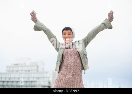 Junge Erfolgsmodell in Winterkleidung lächelnd in die Kamera Stockfoto