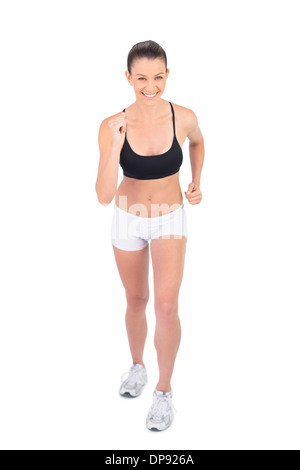 Lächelnde Frau in Sportbekleidung Vorbereitung für Rennen Stockfoto