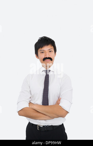 Porträt von zuversichtlich Geschäftsmann mit gefälschte Schnurrbart auf weißem Hintergrund Stockfoto