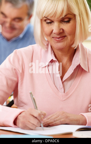 Porträt von Reife Frauen machen Notizen in Copybook mit senior woman auf Hintergrund Stockfoto