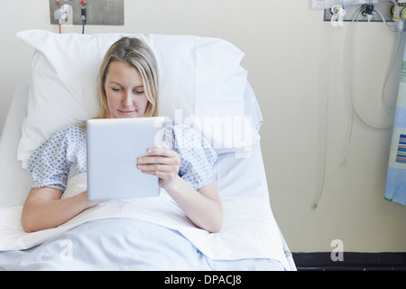 Patienten am Krankenbett mit digital-Tablette liegen Stockfoto