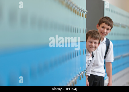 Porträt von zwei Schuljungen hinter Schließfächer Stockfoto