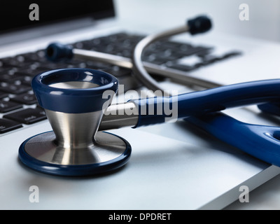 Stethoskop auf Laptop illustriert Online-Gesundheitsfürsorge und des Arztes Schreibtisch sitzend Stockfoto