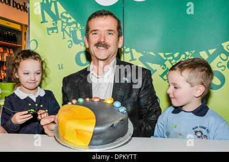 Belfast, Nordirland. 14. Januar 2014 - Kommandant Chris Hadfield mit einem "Solar System-Kuchen" präsentiert, wie er Exemplare seines Buches "An Astronaut Leitfaden zu Leben auf der Erde unterschreibt" Credit: Stephen Barnes/Alamy Live News Stockfoto