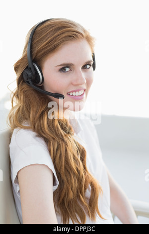 Geschäftsfrau tragen Kopfhörer im Büro Stockfoto