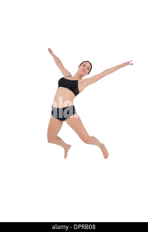 Sportliche Frau tanzt isolierten auf weißen Hintergrund Stockfoto