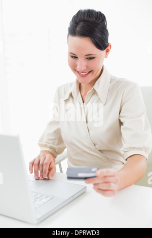 Lächelnde junge Geschäftsfrau machen Online-shopping Stockfoto