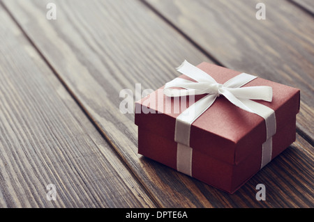 Elegante Geschenkbox auf einer hölzernen Hintergrund-Nahaufnahme Stockfoto