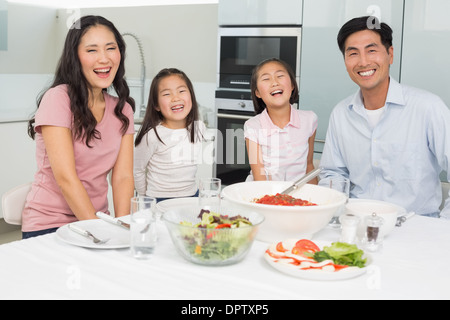 Porträt einer lächelnden Familie sitzen am Esstisch in der Küche Stockfoto