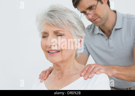 Männliche Physiotherapeuten eine ältere Frau Nacken massieren Stockfoto