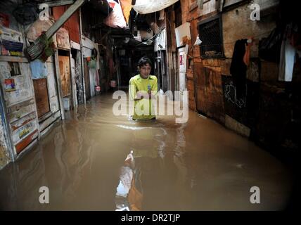 Jakarta, Indonesien. 18. Januar 2014. Ein Mann geht durch das Hochwasser in Jakarta, Indonesien, 18. Januar 2014. Weit verbreitet Überschwemmungen in der indonesischen Hauptstadt Jakarta sieben Toten und Vertriebenen verlassen hat, die etwa 11.000 Menschen mit größeren Überschwemmungen voraussichtlich in den nächsten zwei Tagen durch die heftigen Regenfälle verursacht werden, sagte Sutopo Purwo Nugroho, der Sprecher für nationale Katastrophe Agentur Xinhua telefonisch am Samstag. Bildnachweis: Agung Kuncahya B./Xinhua/Alamy Live-Nachrichten Stockfoto