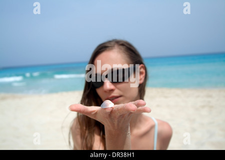 Frau am Strand hält eine Schale, Cala Rajada, Mallorca, Spanien Stockfoto