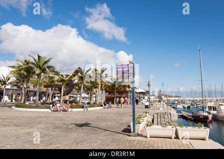 Strandpromenade rund um den Yachthafen im küstennahen Ferienort Puerto Calero, Lanzarote, Kanarische Inseln, Spanien Stockfoto