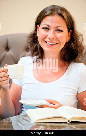 Frau mit einer Tasse Kaffee zu Lächeln Stockfoto