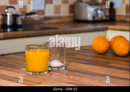 Orangensaft und Zucker, große Mengen an Zucker in Fruchtsäften. Stockfoto