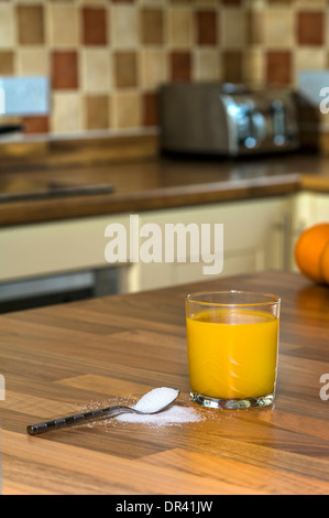 Orangensaft und Zucker, große Mengen an Zucker in Fruchtsäften. Stockfoto