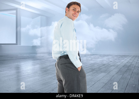 Zusammengesetztes Bild des glücklichen Geschäftsmann stehend mit Händen in den Taschen Stockfoto