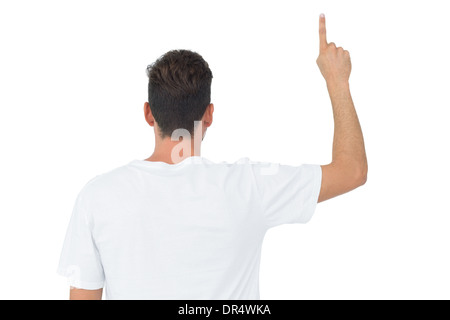 Rückansicht eines jungen Mannes nach oben zeigend Stockfoto
